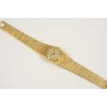 A LADY'S 18CT. GOLD WRISTWATCH BY OMEGA the signed circular dial with baton numerals, on an