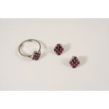A RUBY AND DIAMOND RING centred with nine rectangular-shaped rubies within a surround of small
