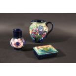 MOORCROFT POTTERY including a vase in the Anemone design, the flowers painted on a blue ground. Also