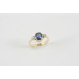 A SAPPHIRE AND DIAMOND THREE STONE RING the oval-shaped sapphire is set with two circular-cut