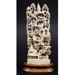 CHINESE IVORY CANTON STYLE CARVING, circa 1900, the hillside scene of figures climbing up from a