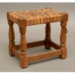 ROBERT THOMPSON OF KILBURN - MOUSEMAN OAK STOOL a carved oak joint stool with octagonal legs and