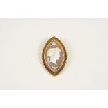 A CARVED SHELL CAMEO BROOCH of navette shape, depiciting the profile of a classical woman, in
