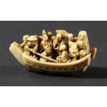 JAPANESE IVORY NETSUKE, by Ikkosai Toun, Edo period, carved as a boat full of people, waves breaking