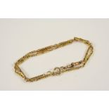 AN 18CT. GOLD WATCH CHAIN formed with alternate oval-shaped links and solid gold links, 34cm. long.,
