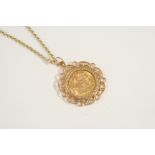 A GOLD HALF SOVEREIGN 1913, in a 9ct. gold pendant mount and on a 9ct. gold circular link chain