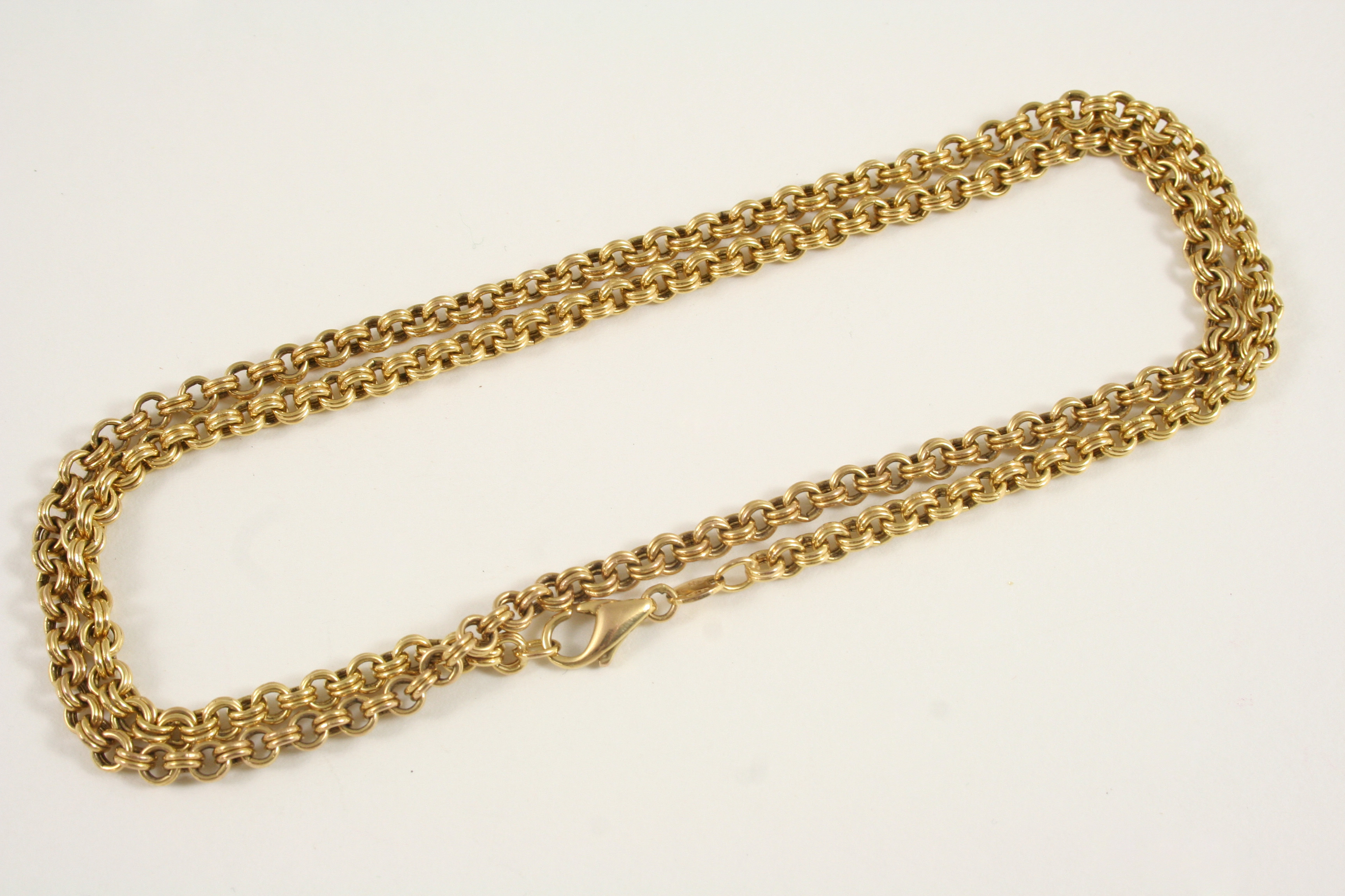 A 9CT. GOLD CHAIN NECKLACE formed with circular double links, 60cm. long, 12.7 grams.