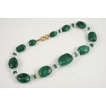 A MALACHITE BEAD NECKLACE formed with graduated oval malachite beads, with crystal and malachite