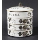 CHINESE SET OF FOUR STACKING DISHES AND COVER, possibly for dim sum, black painted with trailing