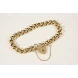 A 9CT. GOLD CURB LINK BRACELET with padlock clasp, 20cm. long, 33 grams.