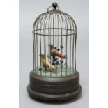 BIRDCAGE AUTOMATON, early 20th century, the two singing birds perched in branches in a domed cage,