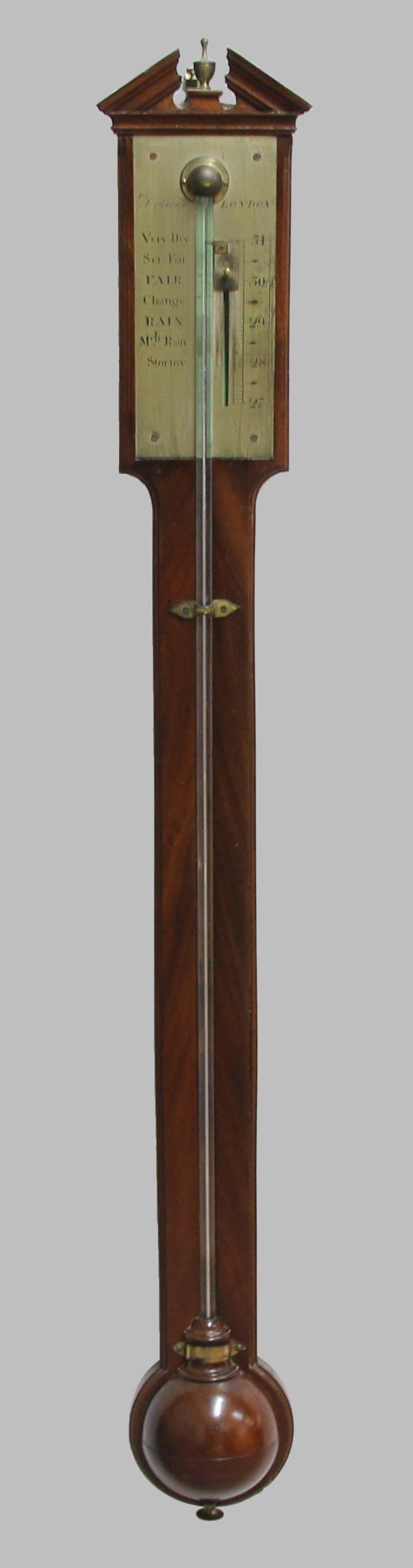 MAHOGANY STICK BAROMETER, with a broken, temple pediment, the gauge inscribed Dolland, London