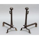 PAIR OF WROUGHT IRON FIRE DOGS, 18th century, with octagonal ball finials and scrolled feet,