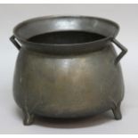 BRONZE CAULDRON, 17th century, of two handled ovoid form with flared rim and three short legs,