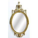 ADAM STYLE GILT WALL MIRROR, 19th century, the oval plate beneath an urn with harebell swags, the