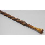 FOLK ART: Carved fruit wood walking stick, the pair of twisting serpents with black glass eyes