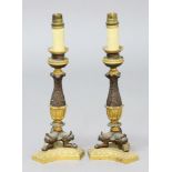 PAIR OF EMPIRE STYLE LAMP BASES, the gilt sconces above bronzed foliate stems of waisted form, on