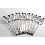 A SET OF TWELVE GEORGE III IRISH TABLE SPOONS Feather-edge pattern, crested, by Christopher