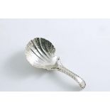 A GEORGE III CADDY SPOON with a bright-cut openwork stem and a chased and fluted shell bowl, by
