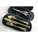 A VICTORIAN CASED PARCELGILT CHRISTENING KNIFE, FORK & SPOON Bright Vine pattern, by George Adams,