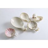 CERAMIC:- Two Spode "Shell" caddy spoons with gilded highlights, a Copeland "Shell" spoon with