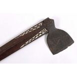 SOLOMON ISLANDS TRIBAL AXE with a tapering wooden shaft inlaid with mother of pearl decoration,