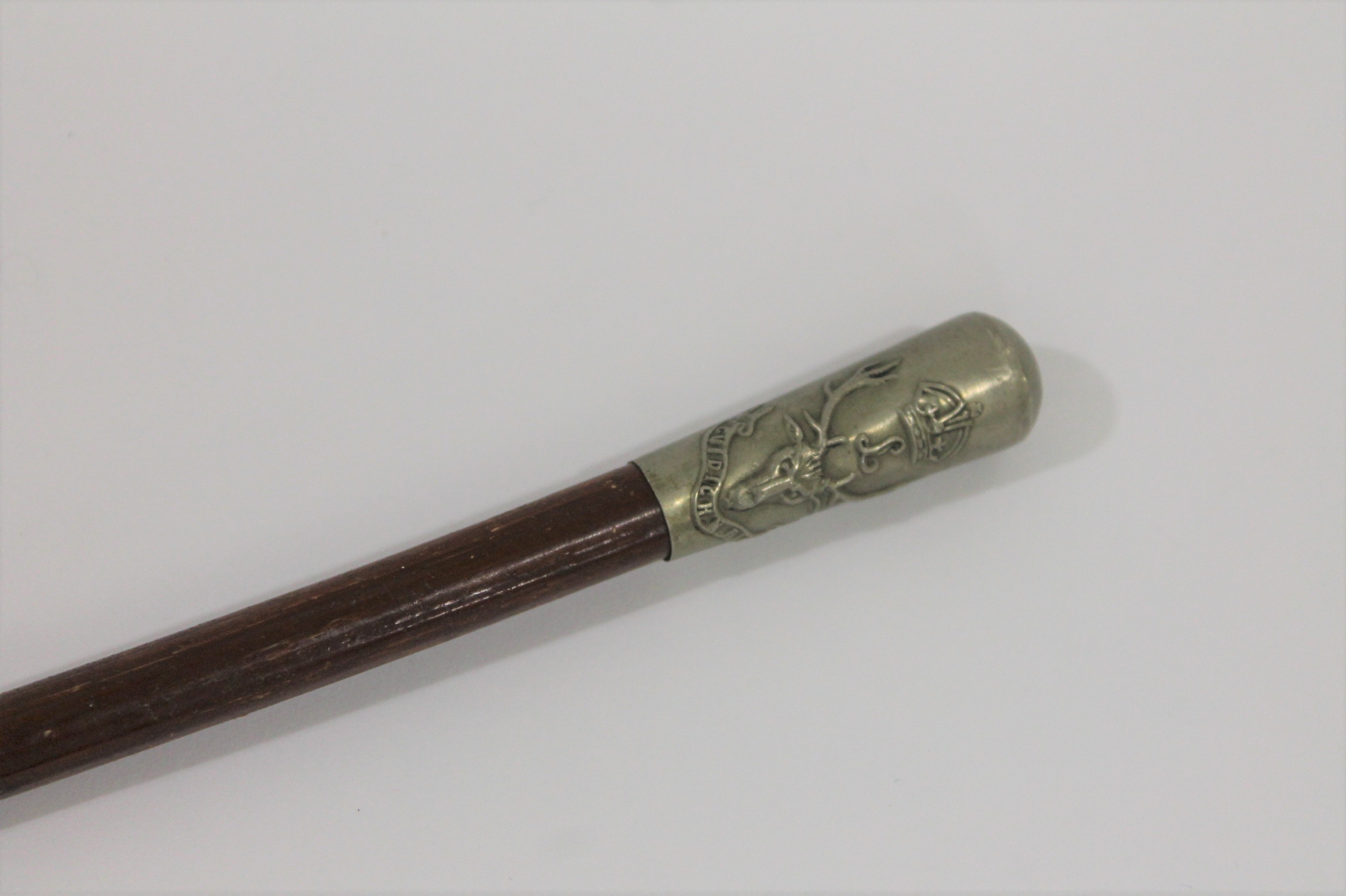 SEAFORTH HIGHLANDERS A swagger stick bearing the Seaforth Highlanders badge of stags head and