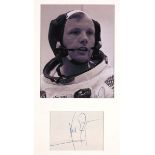 NEIL ARMSTRONG AUTOGRAPH an autograph from Neil Armstrong in blue ink, mounted in a frame with a