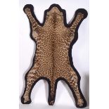 LEOPARD SKIN RUG (Panthera pardus) circa 1930's Leopard skin with a flattened head, mounted on a