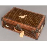 VINTAGE LOUIS VUITTON SUITCASE an early 20thc suitcase, the monogrammed case with leather trim,