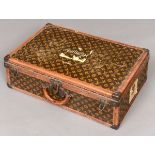 VINTAGE LOUIS VUITTON SUITCASE an early 20thc monogrammed suitcase with leather trim, brass studs