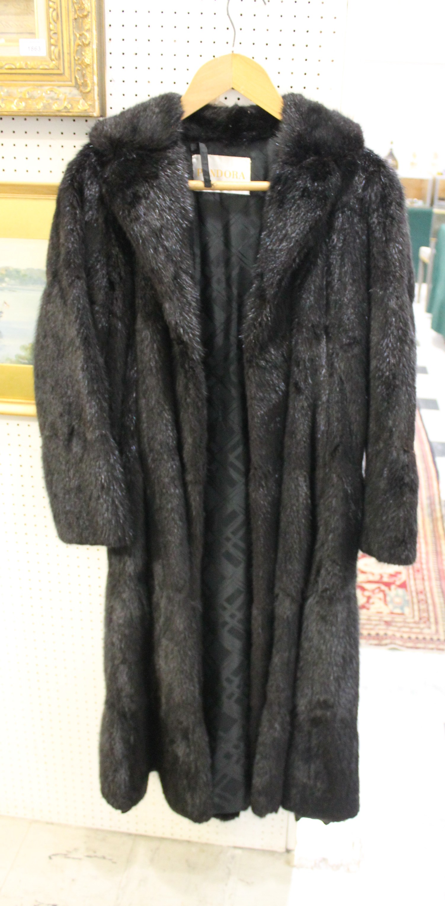 FUR COAT a full length soft styled black fur coat, fully lined with pockets and with a label for