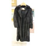 FUR COAT a full length soft styled black fur coat, fully lined with pockets and with a label for