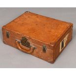 VINTAGE LOUIS VUITTON LEATHER SUITCASE an early 20thc plain leather suitcase, with brass studded and