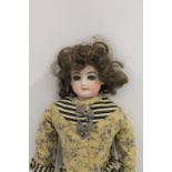 19THC FRENCH FASHION DOLL the doll with a small bisque head, with fixed blue eyes, closed mouth