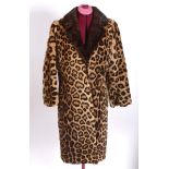 LEOPARD SKIN COAT a full length coat with a fur collar and a silk lined interior, acquired circa