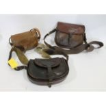 3 VINTAGE LEATHER CARTRIDGE BAGS each of the bags with leather and canvas carrying handles. (3)