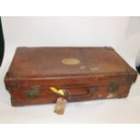 LARGE VINTAGE LEATHER SUITCASE - JOHN POUND & CO the large case with brass and leather handles on