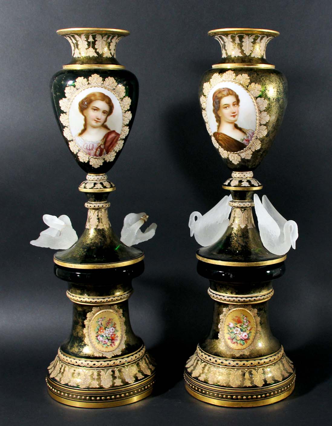 PAIR OF BOHEMIAN GREEN GLASS VASES AND STANDS, late 19th century, each vase painted with a head