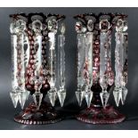 PAIR OF BOHEMIAN GLASS LUSTRES, red cut through to clear with ovals and circles, the flaring mouth