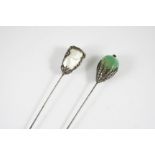 A FRENCH BELLE EPOQUE EMERALD AND DIAMOND HAT PIN mounted with a large emerald in a diamond set