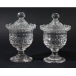 PAIR OF LATE GEORGIAN CUT GLASS HONEY JARS AND COVERS, of footed urn form with faceted decoration,