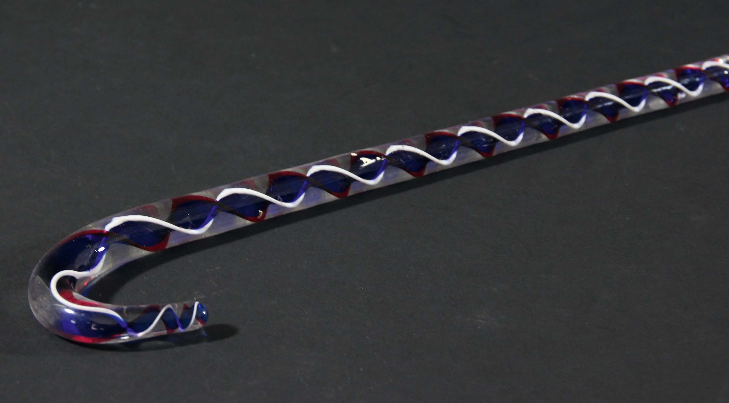 NAILSEA GLASS PIPE, with red and white striations, height 39cm; together with a Nailsea walking