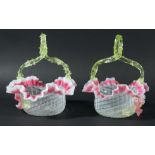 PAIR OF VICTORIAN GLASS BASKETS, the frilled rim with a pink band beneath a scrolled green handle,