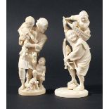 JAPANESE IVORY OKIMONO, Meiji, of a man playing with two boys and a small dog at their feet, red