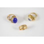 A LAPIS LAZULI AND GOLD RING the oval lapis lazuli cabochon is set in an openwork engraved 14ct.