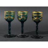 TWELVE TURQUOISE DRINKING GLASSES, late 19th century, the faceted bowls with gilt swag decoration on