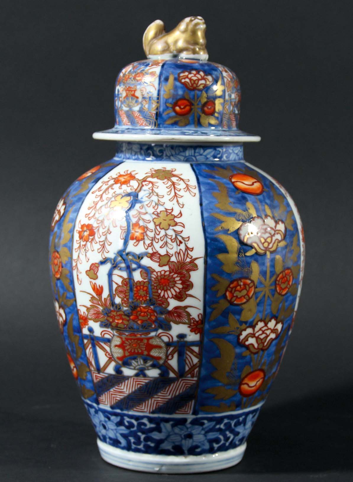 JAPANESE IMARI VASE AND COVER, circa 1900, of ovoid form with alternating panels of flowers and