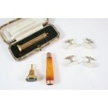 A 9CT. GOLD CIGAR PIERCER with engine turned decoration, 6cm. long, 12.8 grams, with case, an