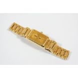 A LADY'S GOLD INGOT WATCH BY CORUM mounted in an 18ct. gold case, quartz movement, numbered to the